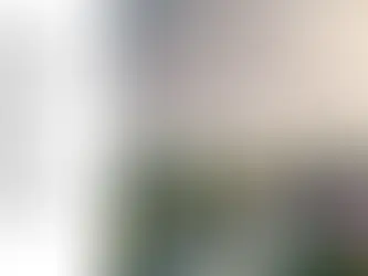 An AI-generated image showing a definition of decarbonization in local government alongside a scene with wind turbines, a river, houses, and a large building resembling the Houses of Parliament.