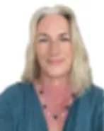 A headshot of Donna Best, a woman with blonde hair and a teal top, wearing a necklace with dark and white beads.