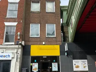 The exterior of 56 Foregate Street, a multi-story building with ground floor shops and a traditional facade, before demolition