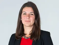 Professional headshot of Rebekah Formosa, a woman with dark hair, smiling.