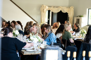 Guests gathered at a decorated dining table for an event.