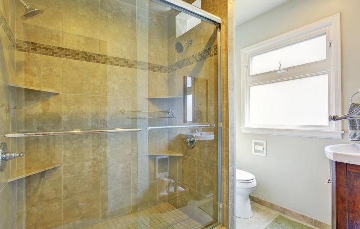 A modern bathroom with shower glass doors.