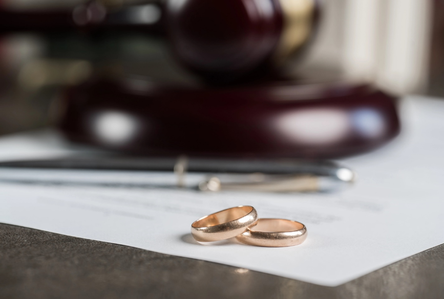 Two wedding bands are placed on a divorce document. 