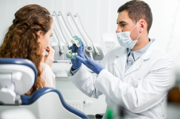 A dentist explaining oral health to a patient.