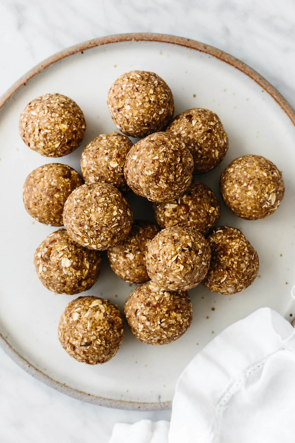 No Bake Banana Bread Protein Energy Balls displayed on a round white plate