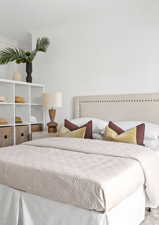 Serene bedroom with timeless staging, wooden beam ceiling, and high-end finishes