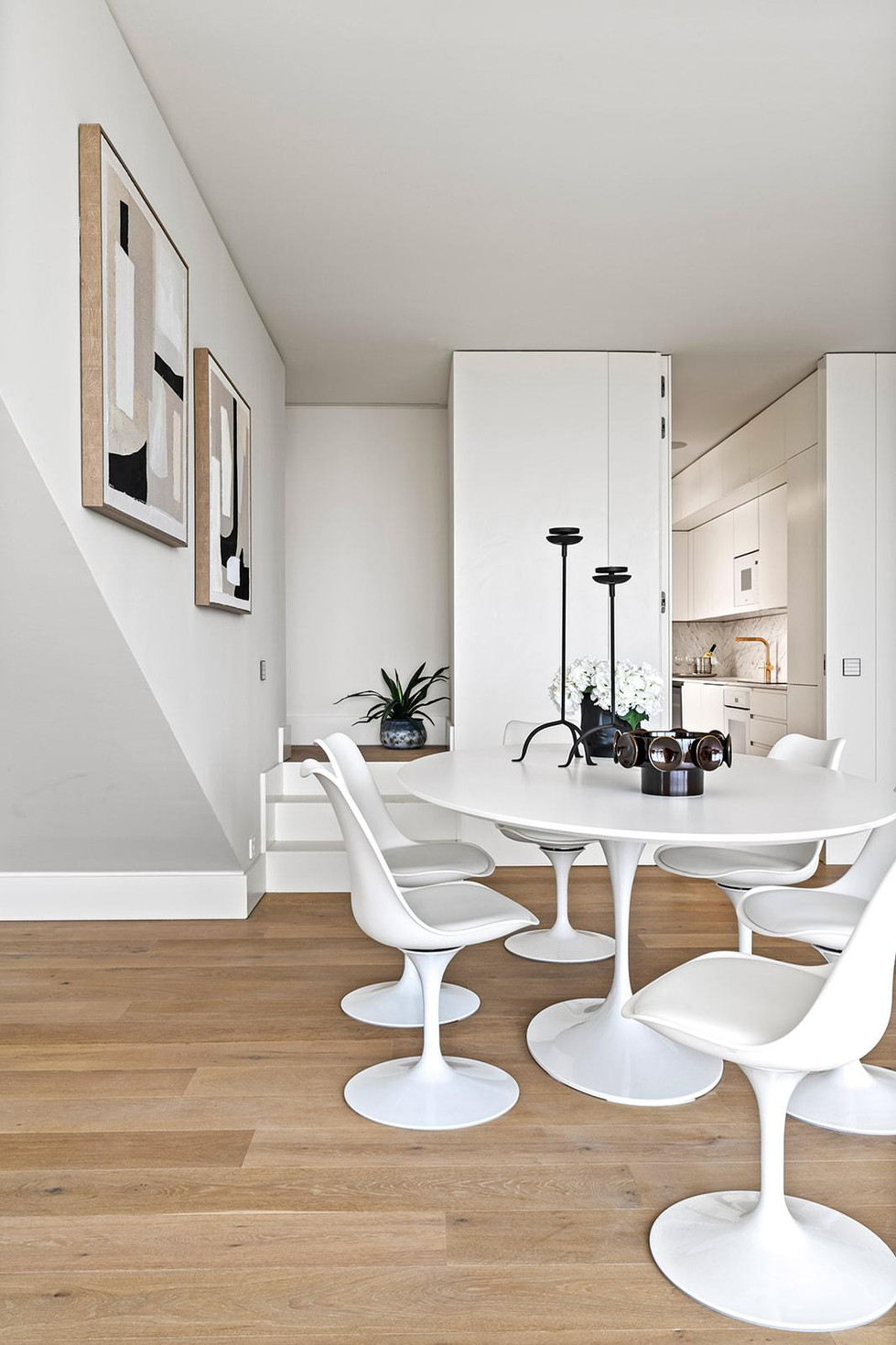 Modern dining area with curved chairs and natural light in urban interior