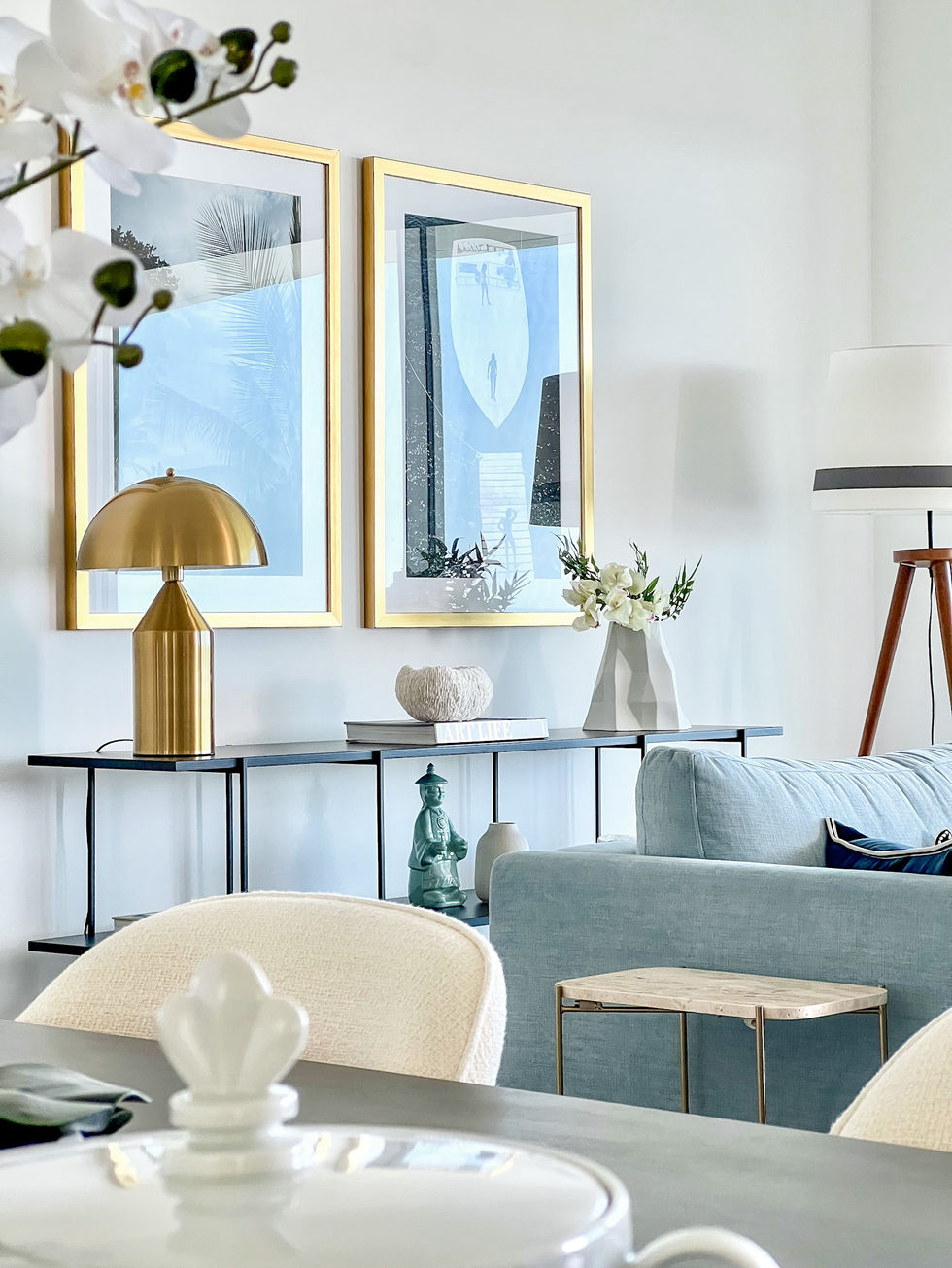 Serene coastal bedroom in Lagos villa, styled with sunlit yellows and coastal blues, evoking the effortless charm of French Riviera living for a peaceful retreat.