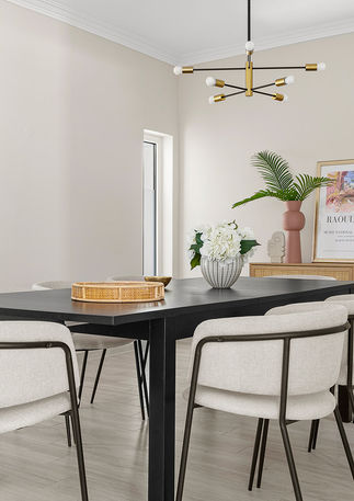 Dining area in Estoril home with coastal styling and luxurious home staging, offering an inviting atmosphere for gatherings.