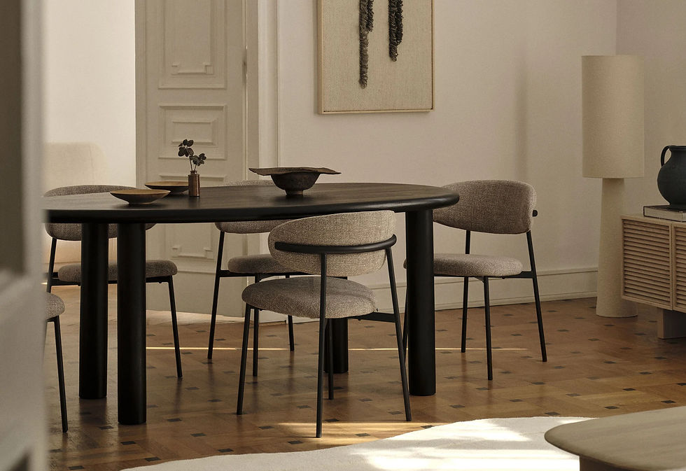 Boutique Hotel Furniture in Portugal | Custom Hospitality Solutions - Modern dining area with dark oval table, beige chairs, and minimal decor. Soft lighting casts shadows on the wooden parquet floor.