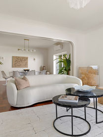 Staged living / dining space with white furniture contrasting dark floors in Birre, Cascais.