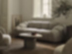 Boutique Hotel Furniture in Portugal | Custom Hospitality Solutions- Cozy living room with a gray, rounded sofa, a round table holding a bowl, and sunlight streaming through a window, creating a calm mood.