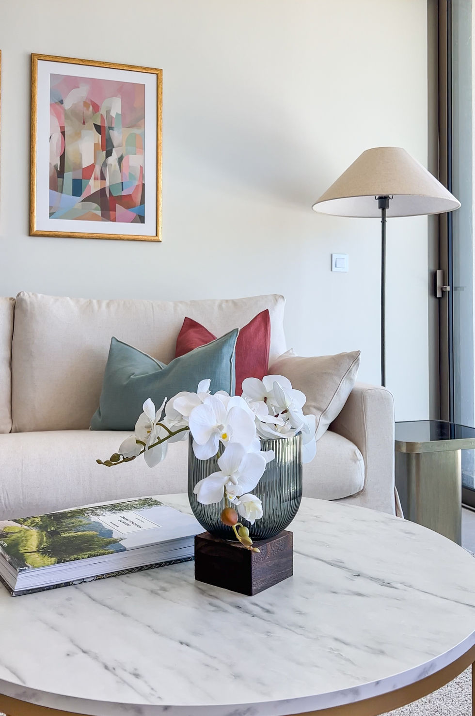 Spacious living room in the Carvoeiro beach resort model unit, styled with coastal-inspired decor and modern furniture, offering a comfortable and elegant space to relax and entertain.