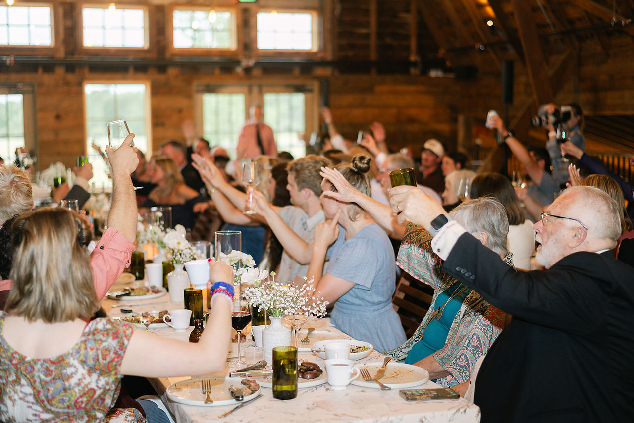 See a Bozeman Montana wedding with a helicopter at Firelight Farm, featuring epic mountain wedding photos, a helicopter entrance, outdoor ceremony and barn reception.