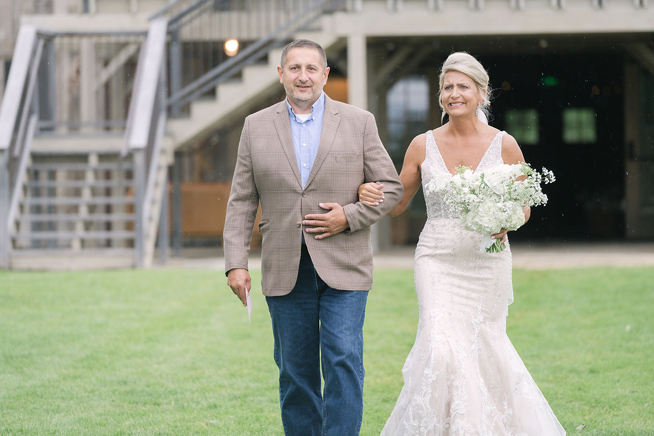 See a Bozeman Montana wedding with a helicopter at Firelight Farm, featuring epic mountain wedding photos, a helicopter entrance, outdoor ceremony and barn reception.