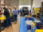Volunteers packing supplies for distribution in a warehouse