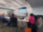 Group of people attending a presentation in a modern meeting room
