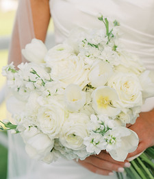 Classic white bridal bouquet with roses and greenery.