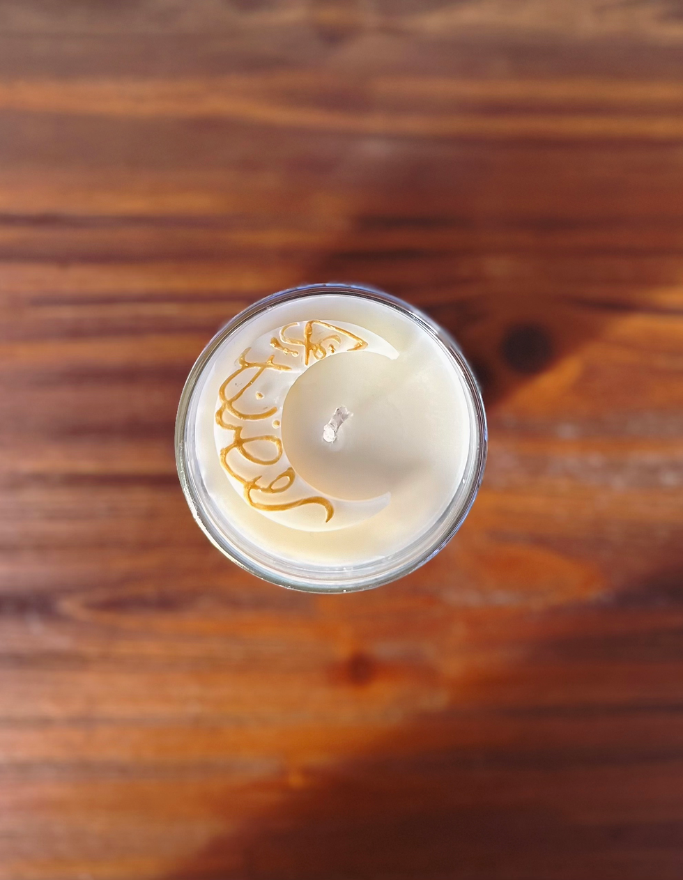 Thumbnail: Top of Night Court Candel featuring a wax moon with golden swirls