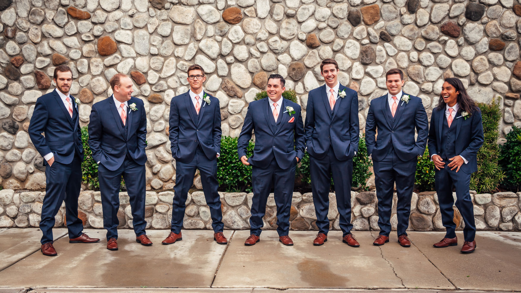 Groom and groomsman chat and hang out before wedding reception.