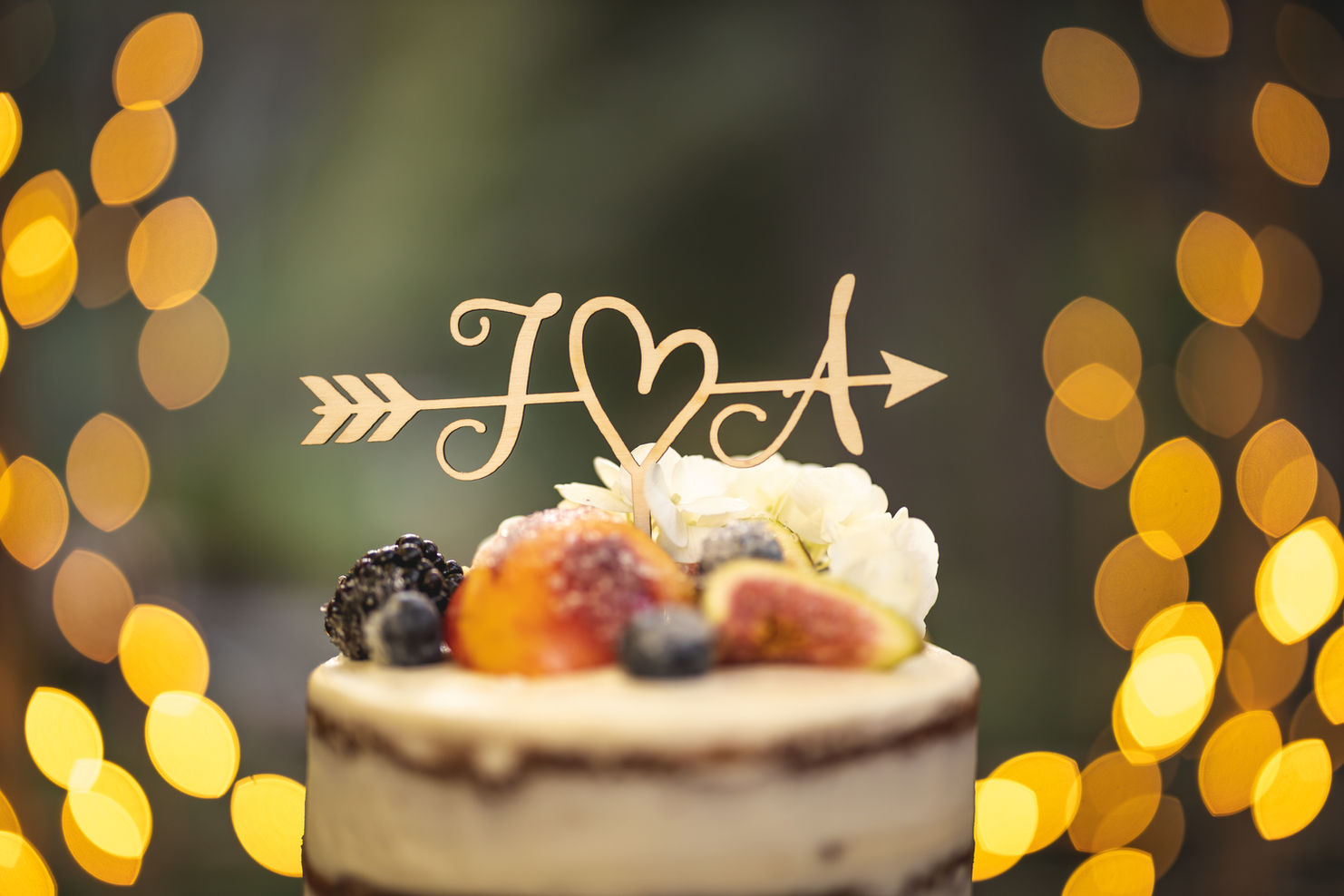 Wedding cake topper with bokeh in the background.