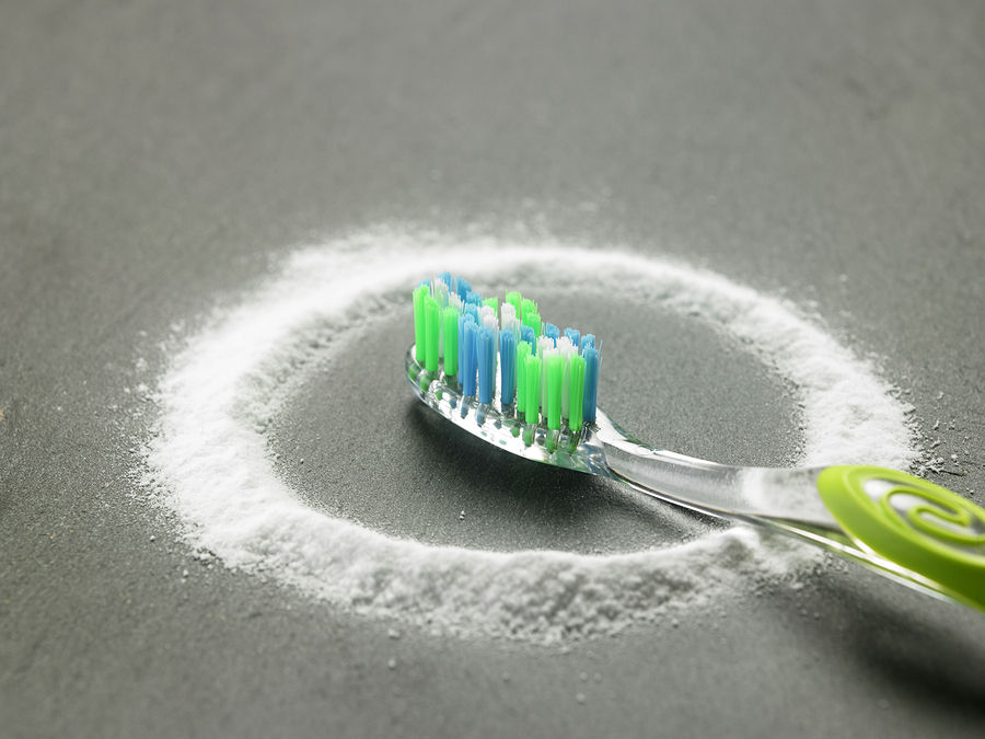 Toothbrush and baking soda. Brushing with baking soda.