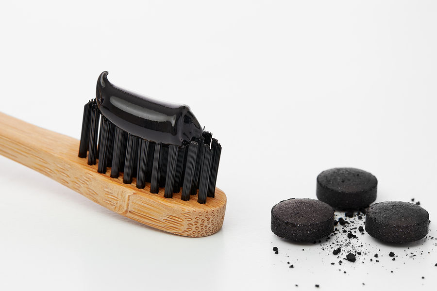 Black toothpaste on toothbrush with activated charcoal