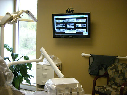 Tacom dentist's treatment room showing big TV monitor