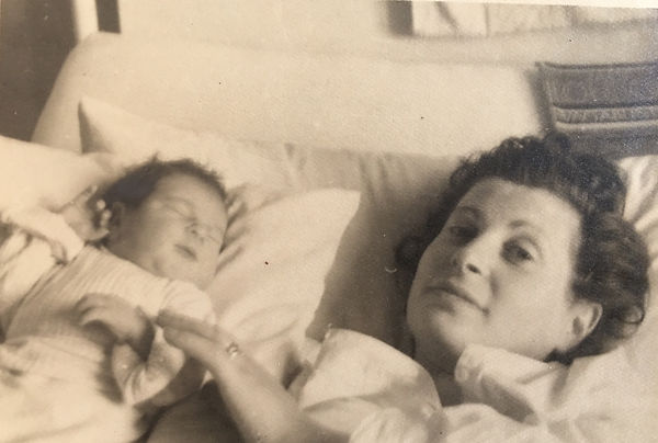 Newborn Fama and her Holocaust survivor mother resting in bed.