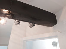 a black beam with two lights hanging from it