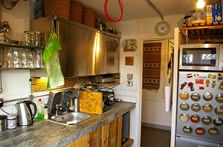 a kitchen with a sink and a clock on the wall