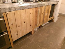 a kitchen counter with wooden cabinets and a marble counter top