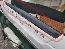 the back of a boat with prestige 34 painted on it