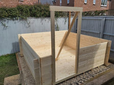 a wooden structure is being built in a backyard