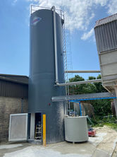 a large silo with the word omega on it