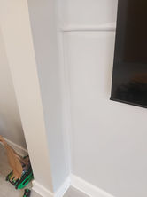 a white wall with a black tv mounted on it