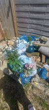a pile of garbage including a bag that says ' dry supply ' on it