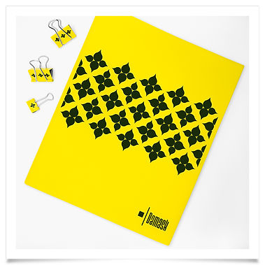 Binder clips and a yellow folder for transporting papers, with a solid black surface design inspired by woven damask fabric.