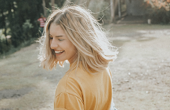 woman walking in white sand during daytime_edited_edited.png