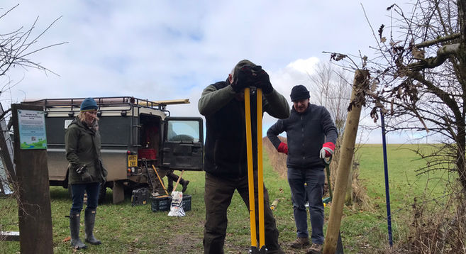3 volunteers installing a gate at Freewarren
