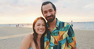 Hispanic Couple on the Beach Smiling.jpeg