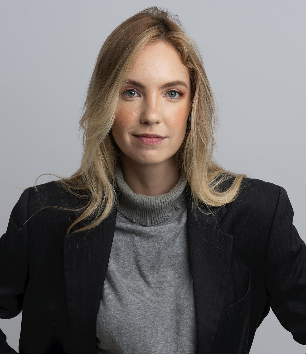 Woman in black blazer and gray turtleneck