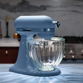 KitchenAid 2026 Luminaire stand mixer in Blue Peppercorn with fluted glass bowl on a countertop