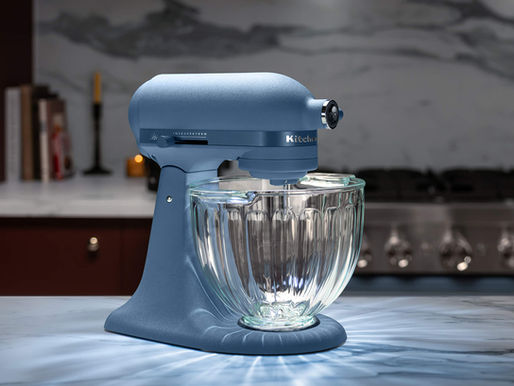 KitchenAid 2026 Luminaire stand mixer in Blue Peppercorn with fluted glass bowl on a countertop
