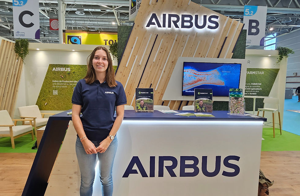 Montaine Foch, agronomist and Product Marketing Manager at Airbus Defence and Space, pictured at the Airbus stand during the Salon International de l'Agriculture in Paris 2026, in front of the Farmstar and Grassland Production Index displays.