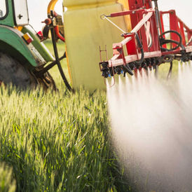 Agricultural pesticide spraying in an EU crop field