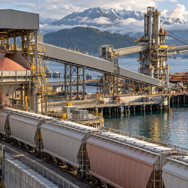 Contextual editorial illustration of a Canadian potash export terminal with railcars, covered conveyors and a bulk carrier