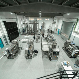 Bioprocess vessels and stainless steel equipment at a factory validation facility in Spain; contextual Unsplash image, not the Danone Michelin site.
