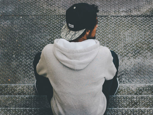 a mand sitting on a step thinking.