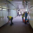 Volunteers cleaning the panels in the underpass at Forest Hill Station